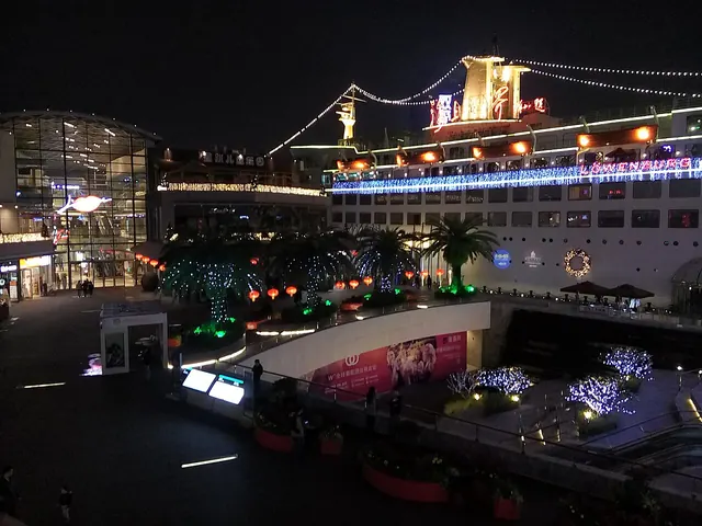 The illuminated Minghua ship and plaza at Sea World in Shekou