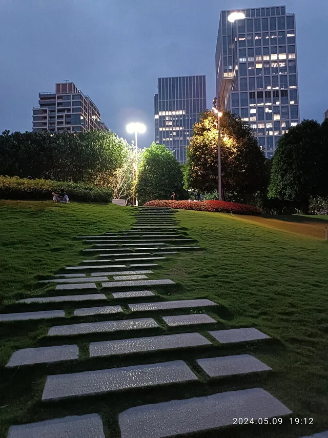 Stepping stones and landscaped slopes at Qianhai Stone Park at dusk