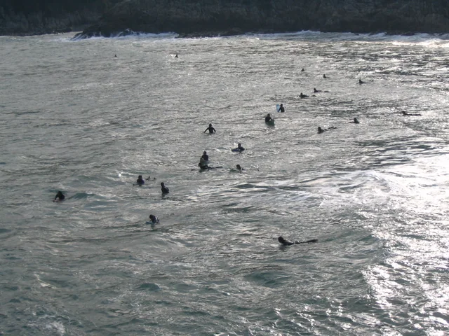 Surfers waiting on their boards at Big Wave Bay on Hong Kong Island