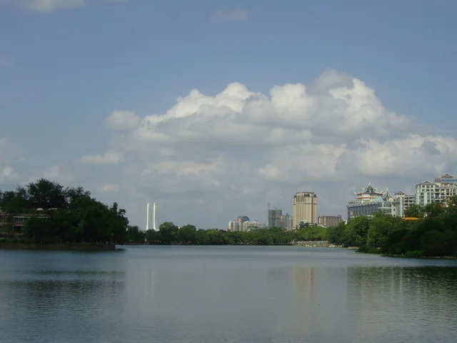 The water, trees and distant buildings beside West Lake in Huizhou