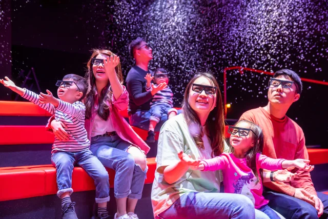 Families wearing cinema glasses during the LEGO 4D experience