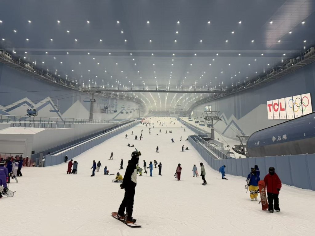 Skiers and snowboarders using an indoor slope at Qianhai Snow World