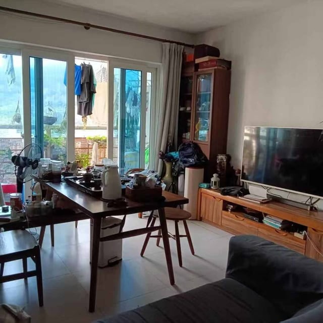 Taoyuan Village III living room as photographed with the current tenant's furniture and appliances, which are not included in this unfurnished rental