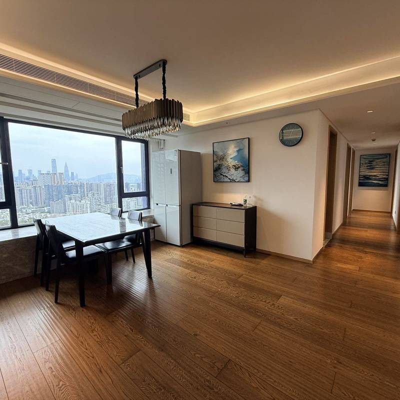 Dining area with wooden flooring and large windows in the advertiser's Peninsula Phase III apartment gallery