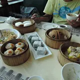 Bamboo steamers of dim sum, dumplings and buns on a restaurant table